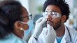 © Studio Nova - Healthcare professional in protective gear taking a nasal swab from a patient for a COVID-19 test.
