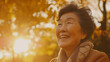 A close up shot of an asian elder woman laughing