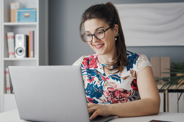 Happy woman working with her laptop