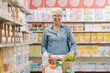 © StockPhotoPro - Confident senior woman doing grocery shopping at the supermarket