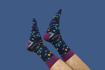 Wall Mural - Colored socks with a print on men's feet.