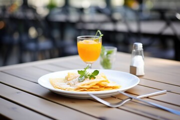 Sticker - crepe suzette served on outdoor cafe table