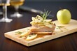 a slate board featuring foie gras on toast with pear slices