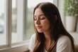 © PNG&Background Image - Young woman sitting near the window closing her eyes and relaxing on a sunny day.