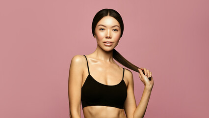 Wall Mural - asian young woman with fit body and long ponitail hair portrait. hair care conceptasian young woman 