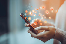 Illustrate Modern Social Media Engagement By Capturing A Smartphone Held By Hands, Vibrant Heart And Like Icons Cascading From The Screen Onto A Blurred Background.