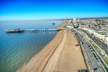 Wall Mural - Aerial view along Brighton Beach towards the Victorian Palace Pier, a popular seaside resort in East Sussex England.