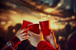Group of friends meeting, clicking disposable plastic red cups over blurred background. Concept of holidays, celebration, events, friendship, leisure activity