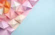 Paper pyramids in different colors and sizes are placed on a pink-blue background. All pyramids are on the left side of the image on the pink part of the wallpaper, the blue one is empty.