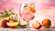 Summer refreshment of pink gin and tonic with ice and peach slices in a stylish glass, peach fuzz