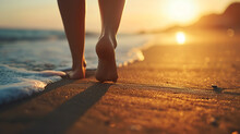 Closeup Of Woman Feet Walking On Sand Beach During A Golden Hour Sunset