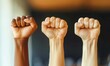 © Kanisorn - people holding their fists in the air, blur office background, Team or Goal in Business concept