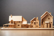 wooden house maquette model with two family sizes and different home affordability and wealth level concepts as the wide banner with copy space area for text design.