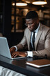 © AI_images - Focused African American manager dressed in elegant suit working over laptop on desk at home
