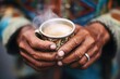 closeup of hands holding a cup of chai with steam rising