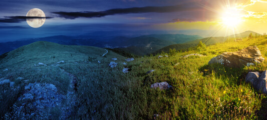 Wall Mural - panoramic landscape with narrow meadow path in grass among white stones on top of mountain range wit