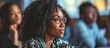 © Ilgun - African American adult education teacher assisting his students during a course in the classroom Focus is on mature woman. Copy space image. Place for adding text