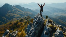 Happy Man With Arms Up Jumping On The Top Of The Beautiful Mountain - Successful Hiker Celebrating Success On The Cliff