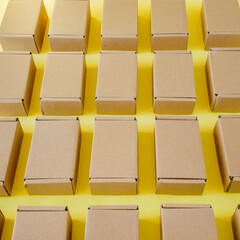 Many cardboard kraft boxes on a yellow background. Packing the parcel.