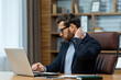 © Liubomir - Concentrated mature man in business attire working at laptop in a well-organized traditional home office, showing professionalism and focus.