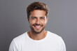 © Daniel - Young man with beautiful smile on grey background