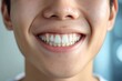 Close-up of a bright smiling Asian young man child showing off healthy white teeth