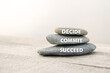 Decide, commit and succeed words written on stones. Motivational advice or reminder