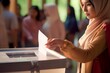 Young muslim woman in voting booth at polling place 