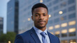 Confident Successful Reliable African American Businessman against defocused Office Buildings background - Young CEO portrait