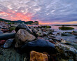 Colorful Sunset and rocks at low tide on the colorful and rocky shoreline on the Gaspe Peninsula on the Gulf of St Lawrence at the village of Perce
