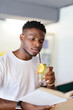 © Andrii Zastrozhnov - Happy and healthy young man, holding a fresh beverage, exuding a cheerful and active lifestyle.
