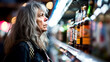 Unhealthy female alcoholic looking at shelves with liquor