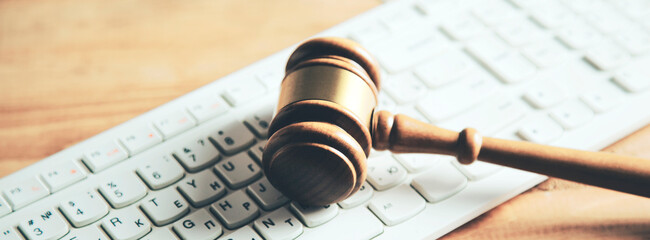 Gavel on keyboard, legal law concept