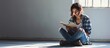 Sad Depressed Mom Holding a Book Sitting on the Floor Unhappy woman reading feeling bored and anxious. Copy space image. Place for adding text