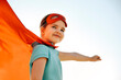 © Dasha Petrenko - Portrait of Superhero kid against blue sky background