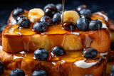 Fototapeta  - Pouring maple syrup on a pancake with blueberries and bananas