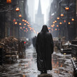 Silhouette of a man in a black robe in a dark alley on a rainy night. Dark character in an imaginary city.