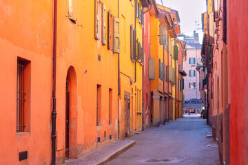 Wall Mural - Bright multi-colored facades of old houses on a narrow street in Bologna.