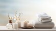 beauty treatment items arranged on a white wooden table, including massage stones, essential oils, and sea salt, a serene spa atmosphere with ample copy space.