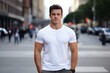 © Dzmitry - Person in white shirt standing amidst modern urban architecture. Young male model.
