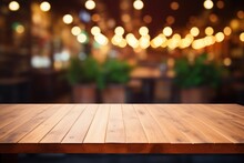 Wooden Table Against Outdoor At Street Evening Bar, Featuring Blurred Defocused Background With Enchanting Lights And Copy Space