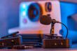 © CesareFerrari - Close up on wireless lavalier microphones, an old fashioned camera is visible in the background, blurred.