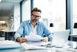 businessman in eyeglasses working with papers at workplace in office