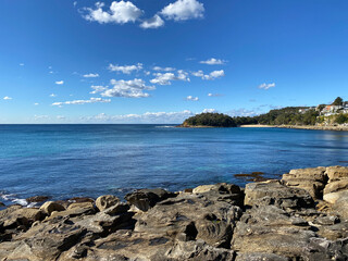 Beach with sky. Rocky coast of the sea. Ocean, mountains, shore and rocks. Bay landscape.