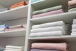 Bed linens and towels on shelves in shop, low angle view