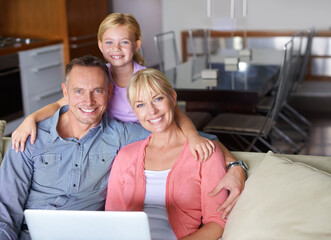 Wall Mural - Portrait, laptop and family on sofa in living room of home for entertainment streaming. Love, smile or happy with mother, father and girl child watching online video on computer in apartment