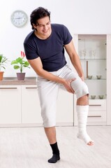 Wall Mural - Leg injured young man suffering at home