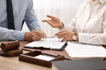 Wall Mural - Lawyers working with documents at table in office, closeup