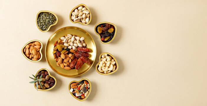 mixed nuts and dried fruits on a gold plates. symbols of the jewish holiday of tu bishvat. healthy s