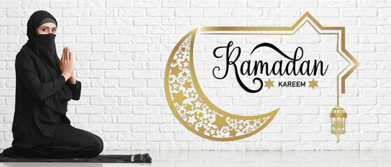 Wall Mural - Praying Muslim woman against white brick wall. Banner for Ramadan